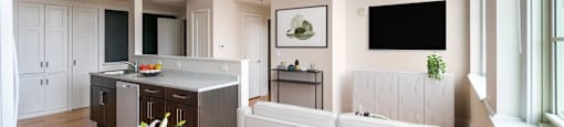 a kitchen and dining room with a white table and chairs at Beverly Village for Living & the Arts Apartments, Beverly