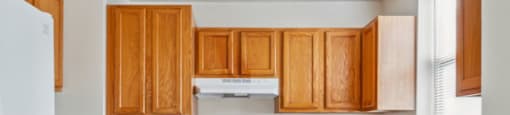 a kitchen with wooden cabinets and white appliances at Monterey Place, New Haven, CT, 06511