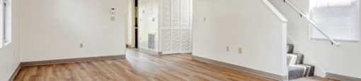 an empty living room with a hard wood floor and white walls at Monterey Place, New Haven, 06511