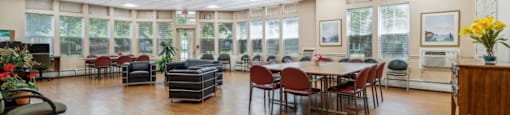a large room with a table and chairs in the center of it  at Monterey Place, New Haven