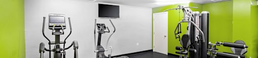 a gym with exercise equipment and green and white wallsat North Stoughton Village, Stoughton, MA