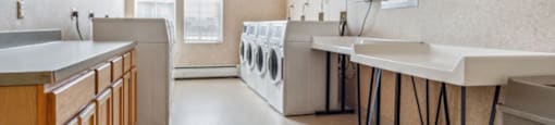 a laundry room with sinks and washes and dryers in it  at Monterey Place, New Haven, CT, 06511