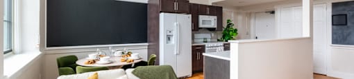 a living room and kitchen with a white couch and a table at Beverly Village for Living & the Arts Apartments, Beverly, 01915