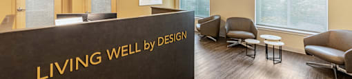 a living well by design lobby with chairs and a reception desk at North Stoughton Village, Massachusetts
