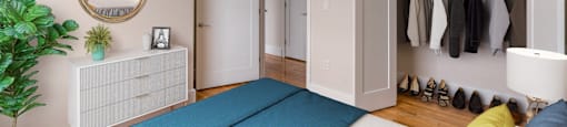 a bedroom with a bed and a closet at Beverly Village for Living & the Arts Apartments, Massachusetts