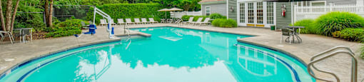 Resort style swimming pool with clubhouse at Woodlands at Abington Station Apartments, Abington, MA 2351