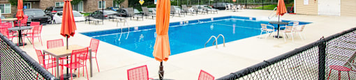 our apartments have a large pool and a patio with chairs at North Stoughton Village, Massachusetts