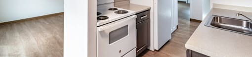 an empty kitchen with white appliances and a white refrigerator at Whittier Terrace, Worcester, MA, 01609