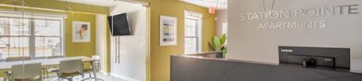 Leasing and Management Office  lobby with a reception desk and a table with chairs at Station Pointe Apartments, Mansfield, MA, 02048