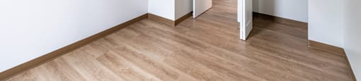 an empty room with white walls and a wooden floor at Whittier Terrace, Worcester, 01609