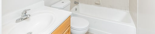 Bathroom With Bathtub And White Finishes. Highland Plaza Apartments, Pittsburgh, PA.