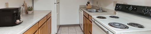 a kitchen with white appliances and wooden cabinets