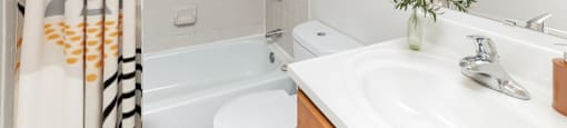 a bathroom with a shower and a sink and a bath tub