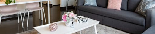 a living room with a couch coffee table and a dining table at Dorado Apartments, Yonkers, 10701