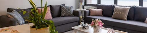 a living room with a large window and a view of a body of water at Dorado Apartments, Yonkers, NY