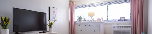 a bedroom with a large bed in front of a window at Dorado Apartments, New York