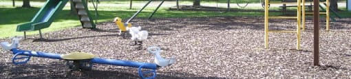 a playground with a swing set and a childs swing