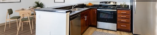 A kitchen with wooden cabinets and stainless steel appliancesA kitchen with wooden cabinets and stainless steel appliances at Pondside at Littleton Apartments in Littleton, MA, 01460