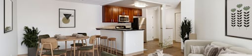 A living room with a dining table  at Pondside at Littleton Apartments.e and chairs
