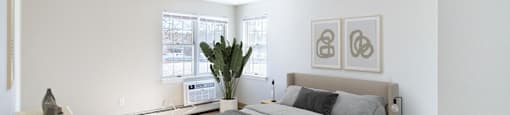 A bedroom with a large bed  at Pondside at Littleton Apartments.