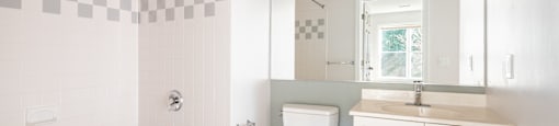 Modern bathroom with tub and vanity at Woodlands at Abington Station Apartments, Abington Massachusetts