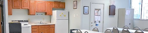 Community Room with Kitchen and Seating Area. at Montani Towers, Wheeling West Virginia