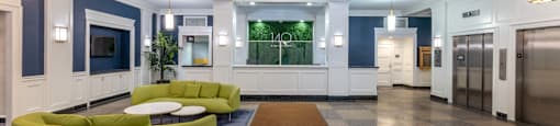 a lobby with blue and white walls and a green couch  at 140 Clarendon, Massachusetts, 02116