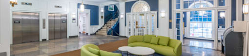 a lobby with couches and a table and a staircase  at 140 Clarendon, Boston, MA