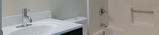 Bathroom with dark wood cabinets at Pondside at Littleton Apartments at Pondside at Littleton, Littleton, MA, 01460