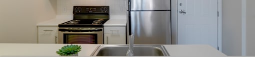 a kitchen with white counters and a stainless steel refrigerator at Ninth Square Apartments, New Haven, CT
