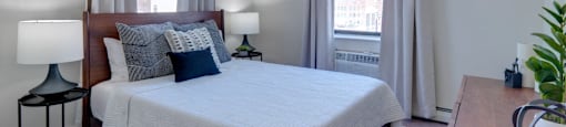 a bedroom with a large bed and two windows at Ninth Square Apartments, Connecticut, 06510