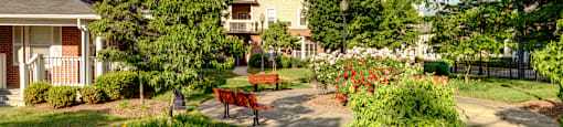 a park with a bench in front of a building  at Monterey Place, New Haven, CT, 06511