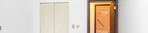 Bedroom with Closet and Bathroom with Grab Bar at Olympia Place.