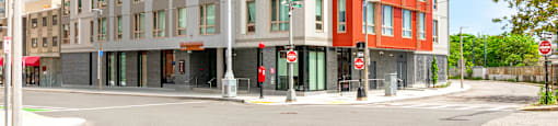 A modern multi-story building with a red and grey facade.