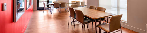 A conference room with a long table and chairs.