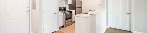 a renovated kitchen with white cabinets and stainless steel appliances at Ninth Square Apartments, Connecticut, 06510