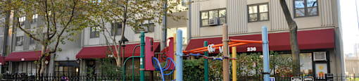 a playground in front of an apartment building at Tai Tung Village, Boston
