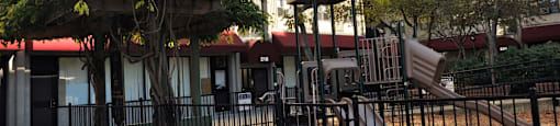 a children's playground in the middle of an apartment building at Tai Tung Village, Boston, 02111