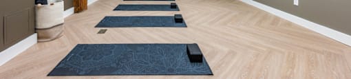 A yoga studio with wooden floors and mats.