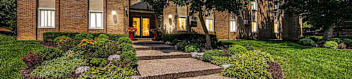 a walkway in front of a brick building