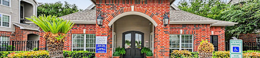 A brick building with a sign that says "Welcome to Veterans Village.".