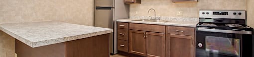 a kitchen with wooden cabinets and stainless steel appliances