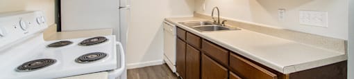 a kitchen with wooden cabinets and white appliances