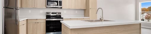 A modern kitchen with wooden cabinets and stainless steel appliances.