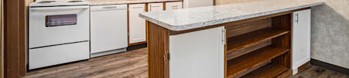 a kitchen with white appliances and white cabinets