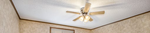 a living room with a ceiling fan and a window