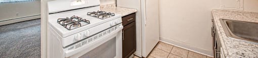 a kitchen with white appliances and brown cabinets