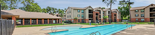 A swimming pool in front of apartment buildings.