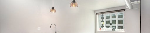 234 Market Apartments In Grand Rapids, MI With Renovated Kitchens featuring a quartz countertop island