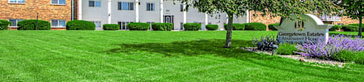 a large brick building with a tree in front of it